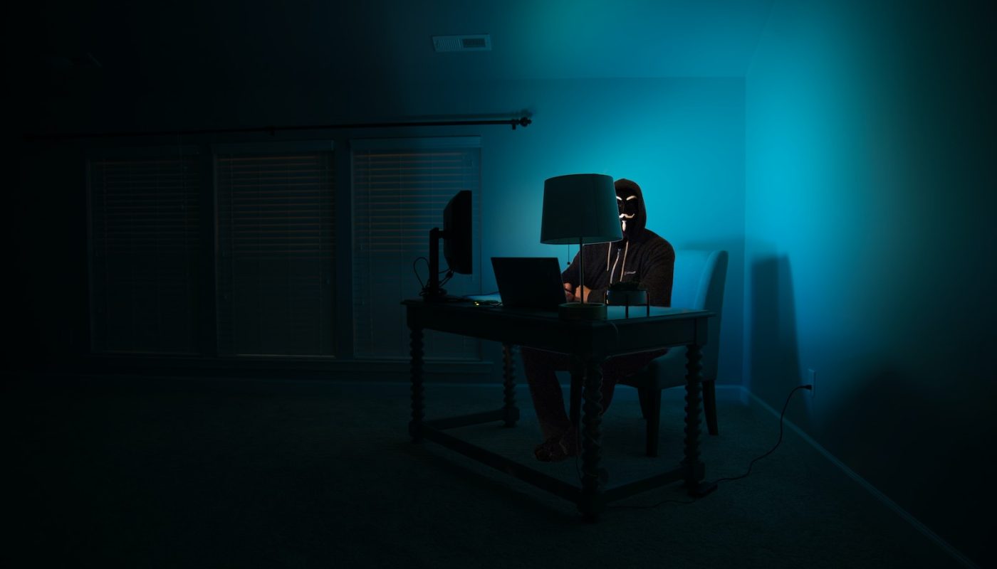 man siting facing laptop