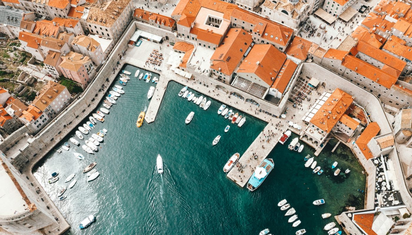 aerial photography of boats on pier and city